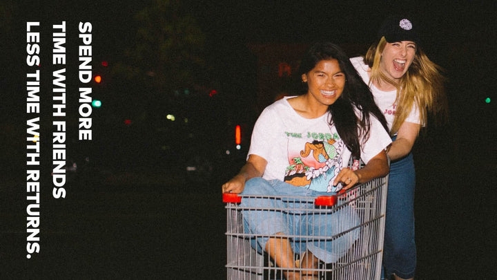 Girls in a shopping cart at night