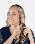 Women wrapping her hair around the curling headband